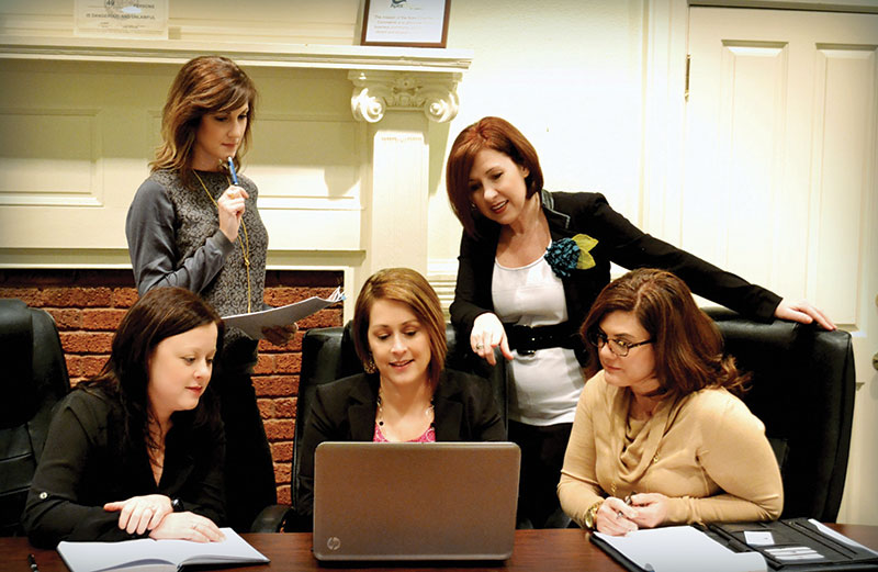 Jennibeth Brackett, seated behind computer, and Missy Gower, standing at right, founded Career Crafters for You to coach men and women returning to the workforce after a gap. They are with Leann Jackson, Meghan Taylor and Catherine Shireman.