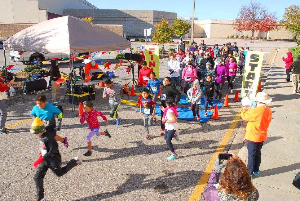 Energetic children are first off the starting line at the Cozy Toes Fun Run.