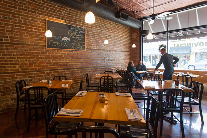 The Provincial’s cozy dining area puts the building’s history on display, showing off exposed brick and a tin ceiling.
