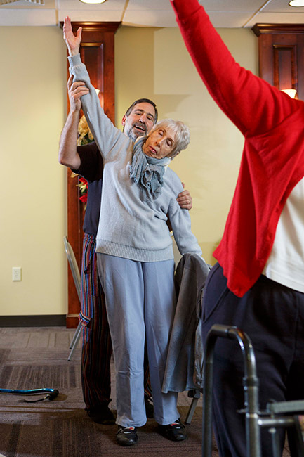 You Call This Yoga founder Howie Shareff helps Margaret Martin with a standing pose during a class held at Crabtree Chiropractic in Raleigh.