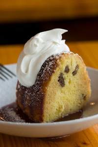 Caribbean rum cake with caramel sauce and whipped cream