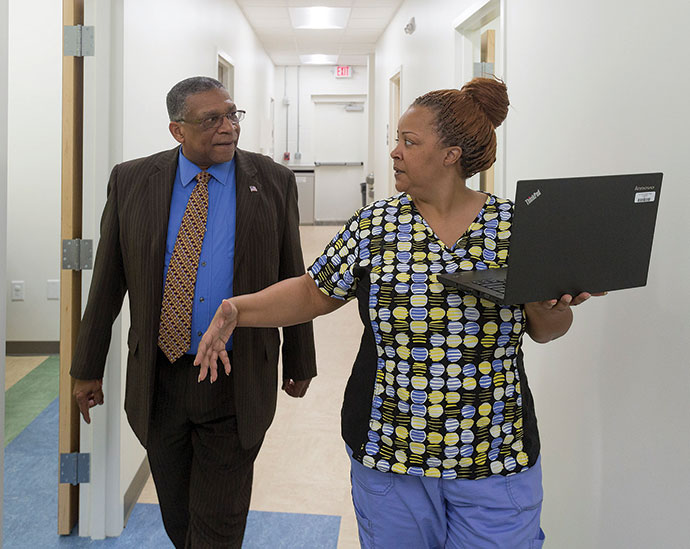 Above: Medical assistant Tawana Daniel speaks with Howard Manning, executive director of Dorcas Ministries.