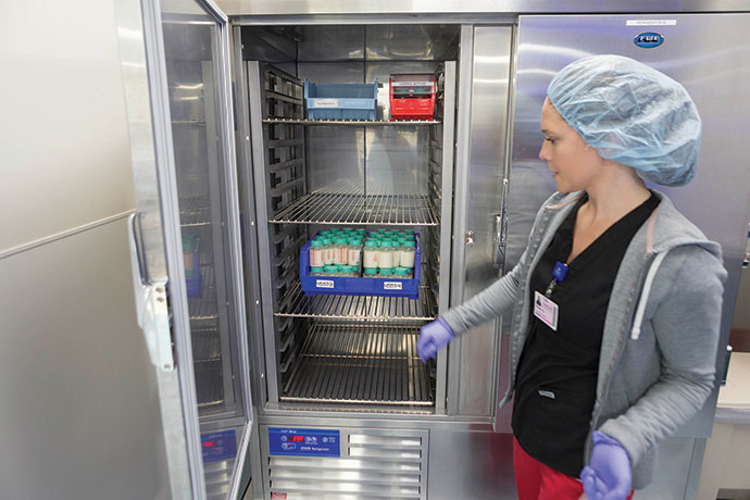 Donated breast milk is checked in by pasteurization technician Missy Abi-Najm and undergoes a multi-step process at the WakeMed Mothers’ Milk Bank. 