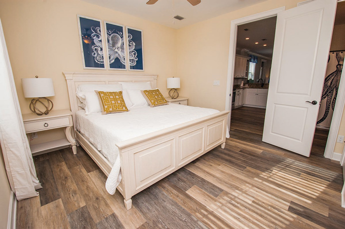 The beachy decor, like the octopus print above the bed, left, “wouldn’t go in my house in Cary,” confessed Kim Hall, but she loves the look for the family’s island home.