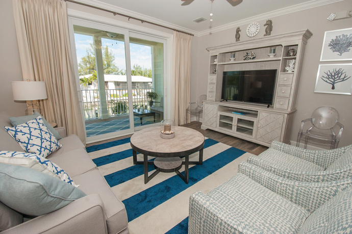 Owner Kim Hall says the living room is her favorite space in her Marathon, Fla., home. Neutral colors are accented with pops of blue and ocean-themed accessories to create a relaxing, coastal atmosphere.