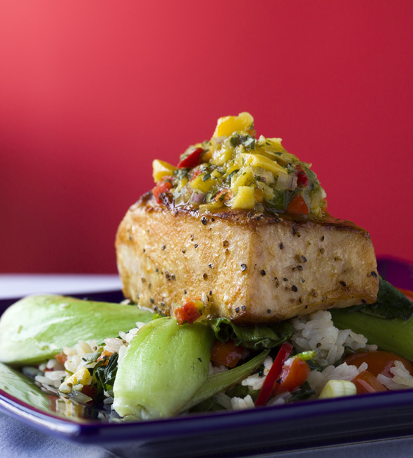 Grilled Hawaiian opah, a flavorful yet mild fish, is served with rice, grilled bok choy, and a tropical pineapple mango salsa.