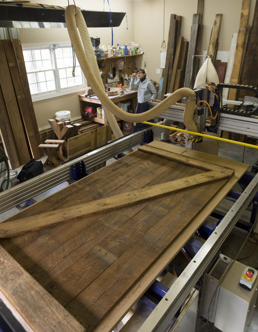 The new barn door, made of old wood, takes shape in Thompson’s Fuquay-Varina workshop.