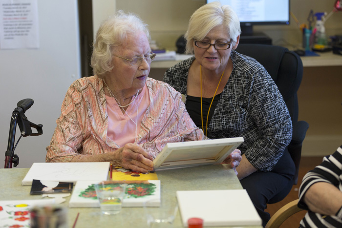 Accomplished artist Jeanette Brooks share her work with Waltonwood life enrichment director Christina Henderson. “The arts help (seniors) express themselves in ways words do not,” Henderson says,” and build meaningful interactions.”
