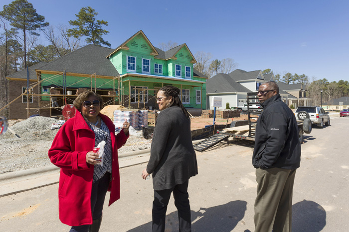 Moving back “home” after 30 years of living in Maryland, Joscie and Chris Barnes couldn’t find their must-haves among local home inventories, namely a first-floor master, backyard privacy and a basement. So, they decided to build their new home at Piazza at Stonewater in Cary, near I-540. The Barnes’ real estate agent, Peggy Dixon, left, says the completion of I-540 will open up new options for families moving to the area, by reducing commute times.