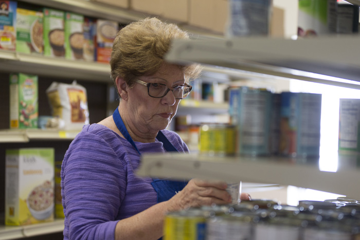 Western Wake Crisis Ministry volunteer Reni Robbins stocks dry goods at the Apex warehouse.