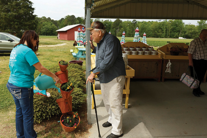 Landowner Don Sorrell talks with Jessica Jones, who runs DJ’s with her husband Darin. “We both enjoy it, and it is rewarding to plant something and then harvest it — to be able to share it with others,” she says.