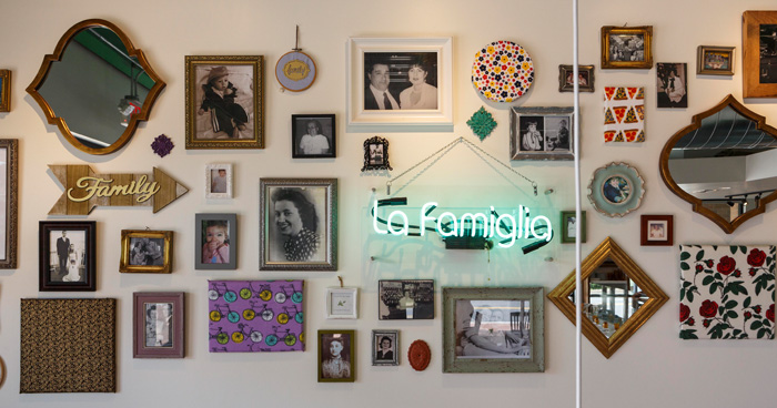 Family pictures of owners Zach and Amber Faulisi decorate the cozy dining room at Pizzeria Faulisi in downtown Cary.