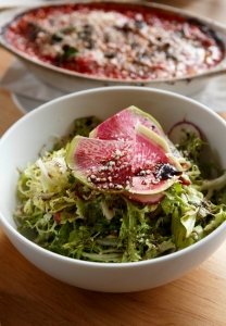 Appetizers, such as the salad with baby greens and Parmesan, remain constant, but toppings change daily depending on season and market availability. 