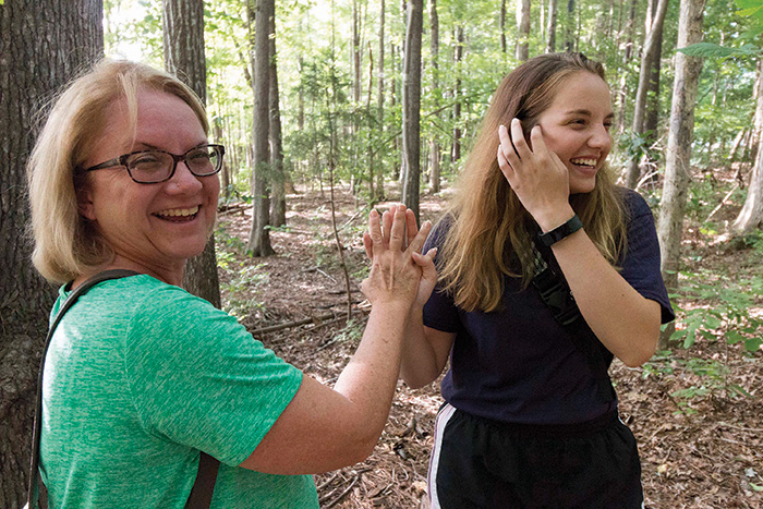 Kim, left and Nicole Howren high five in celebration after finding their first cache together. 