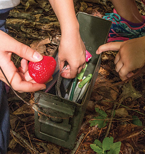 Delaney and Alexis search their treasure to find something to take. In exchange, Delaney leaves a toy strawberry.