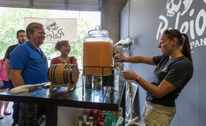 Stephanie Mendler mixes rum-based beverages so visitors to the distillery can sample the company’s products. 