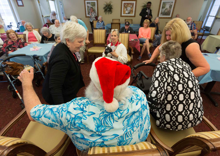 After singing Christmas carols with the four Santas, residents of Brookdale MacArthur Park sat with Santa and had their photos taken. 