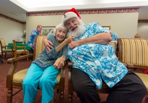 Brookdale MacArthur Park resident Casey Griffen, 87, tugs on Santa's beard.