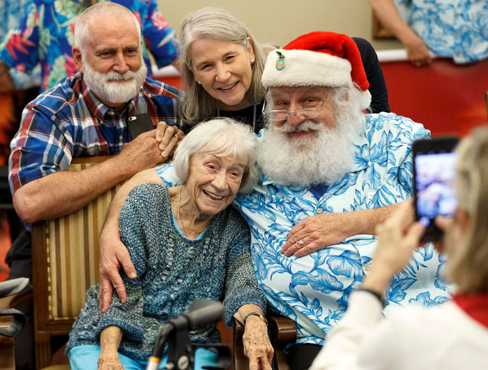 Casey Griffen, poses with her daughter Leigh Duque, son-in-law Tony Duque, and Santa Ron Campbell. “Christmas is all about families, and we get a chance to share that,” says Campbell.