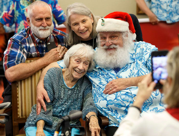 Casey Griffen, poses with her daughter Leigh Duque, son-in-law Tony Duque, and Santa Ron Campbell. “Christmas is all about families, and we get a chance to share that,” says Campbell. 