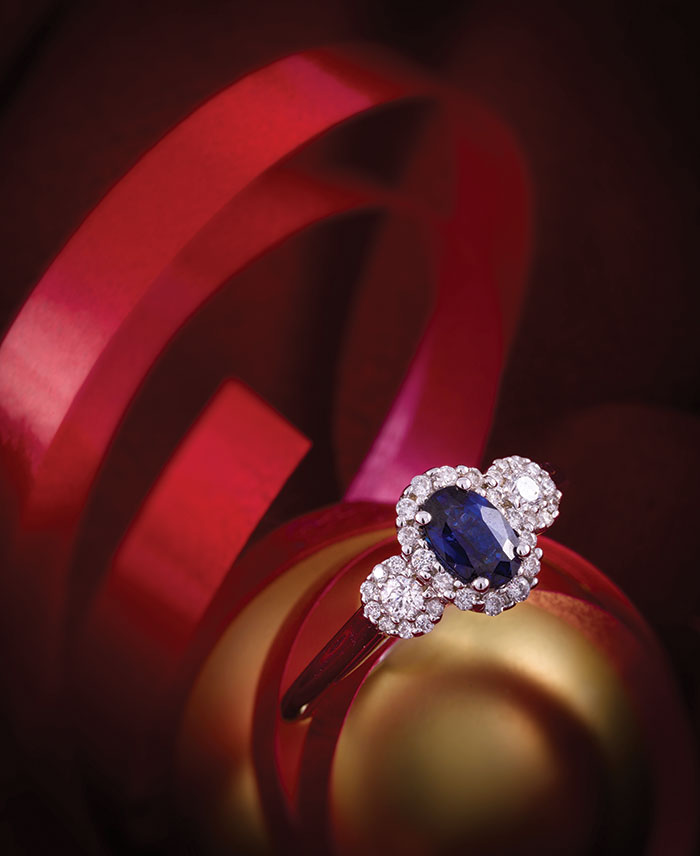 This three-stone ring with a blue sapphire and diamonds from Johnson Jewelers is set in 14K white gold.