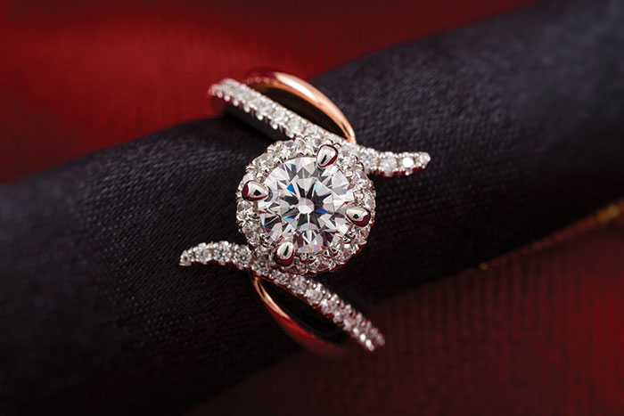 This round halo engagement ring from Anfesa’s Jewelers features 14K white and rose gold.