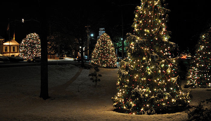 Nearly 400 trees and many homes are lit with red, white and green lights. Nearly 600,000 visitors each year walk along the wreath-lined route through the center of McAdenville, N.C.