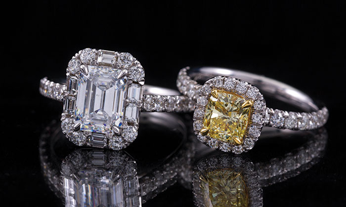 These rings from Diamonds Direct are examples of the popular halo style. The emerald-cut diamond engagement ring, left, has a halo of round brilliant- and baguette-cut diamonds. The yellow cushion-cut diamond ring, right, has a halo of round brilliant-cut diamonds. 